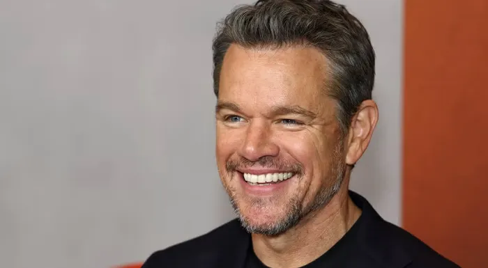 Water.org cofounder Matt Damon smiles in front of a white background.