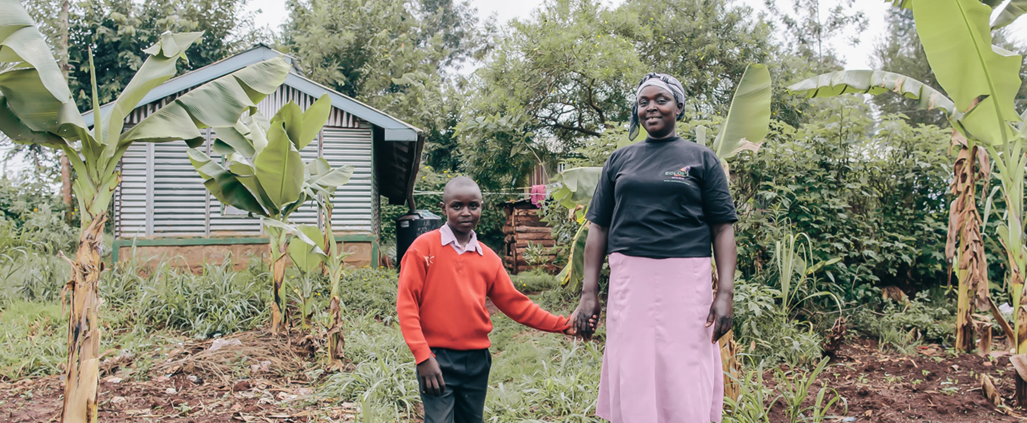 Sabina and her son at their farm in Kenya