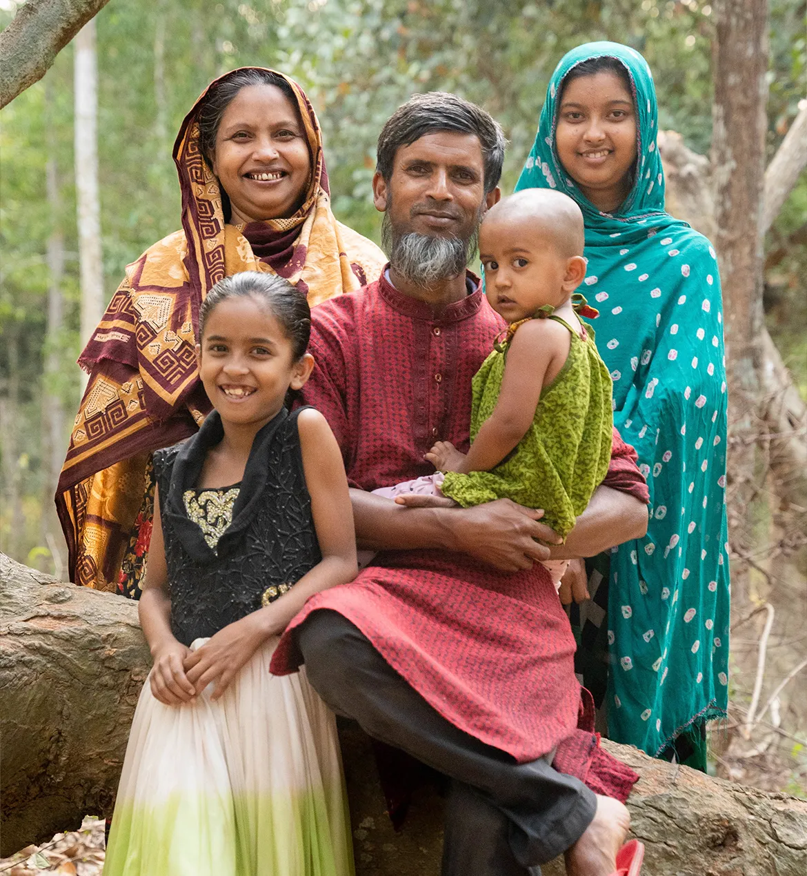 A couple posing with their 3 children in Bangladesh.