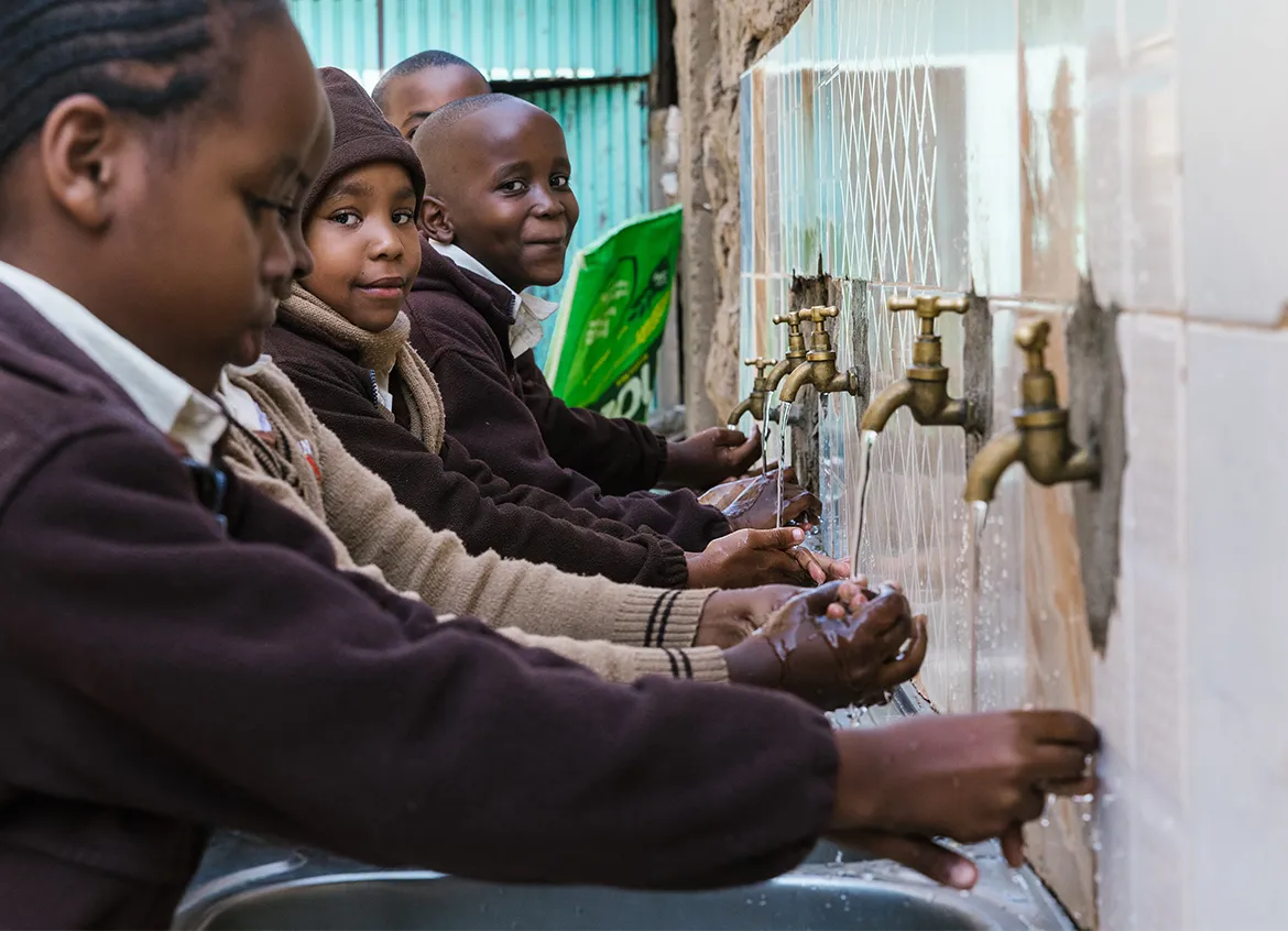 Children washing their hands at school.