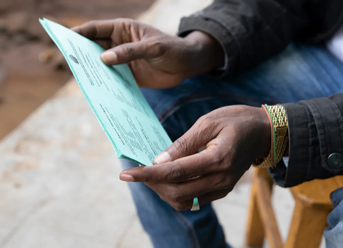 Person holding paperwork with information about WaterCredit.