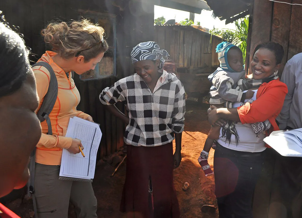 Water.org team members speaking with a family in their home.