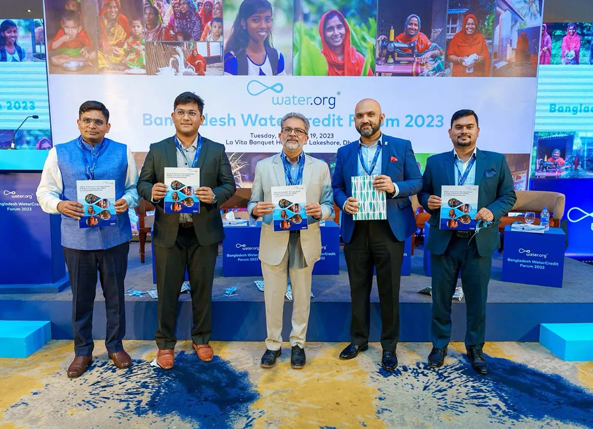 Team members standing together at the Bangladesh WaterCredit Forum.