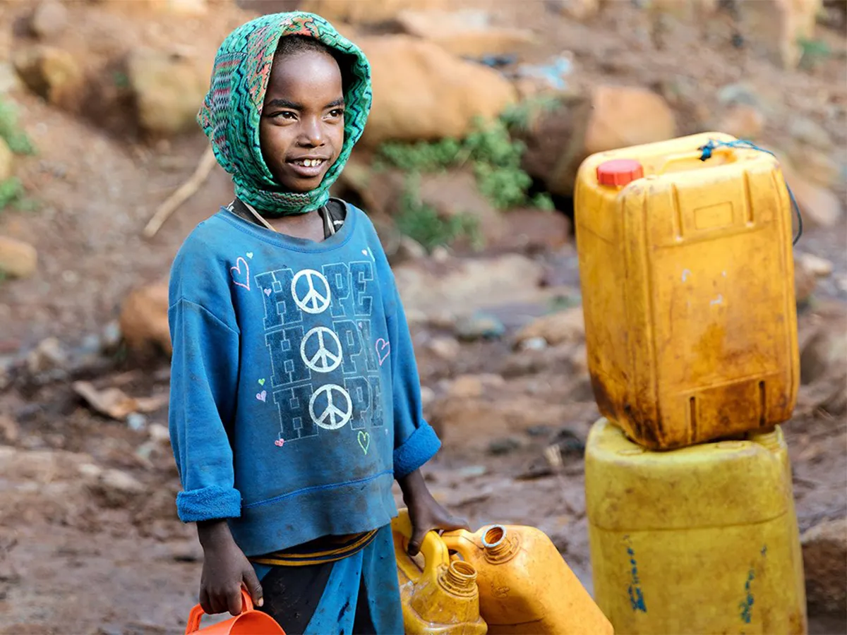 A child in Ethiopia holding a jerry can used to collect water