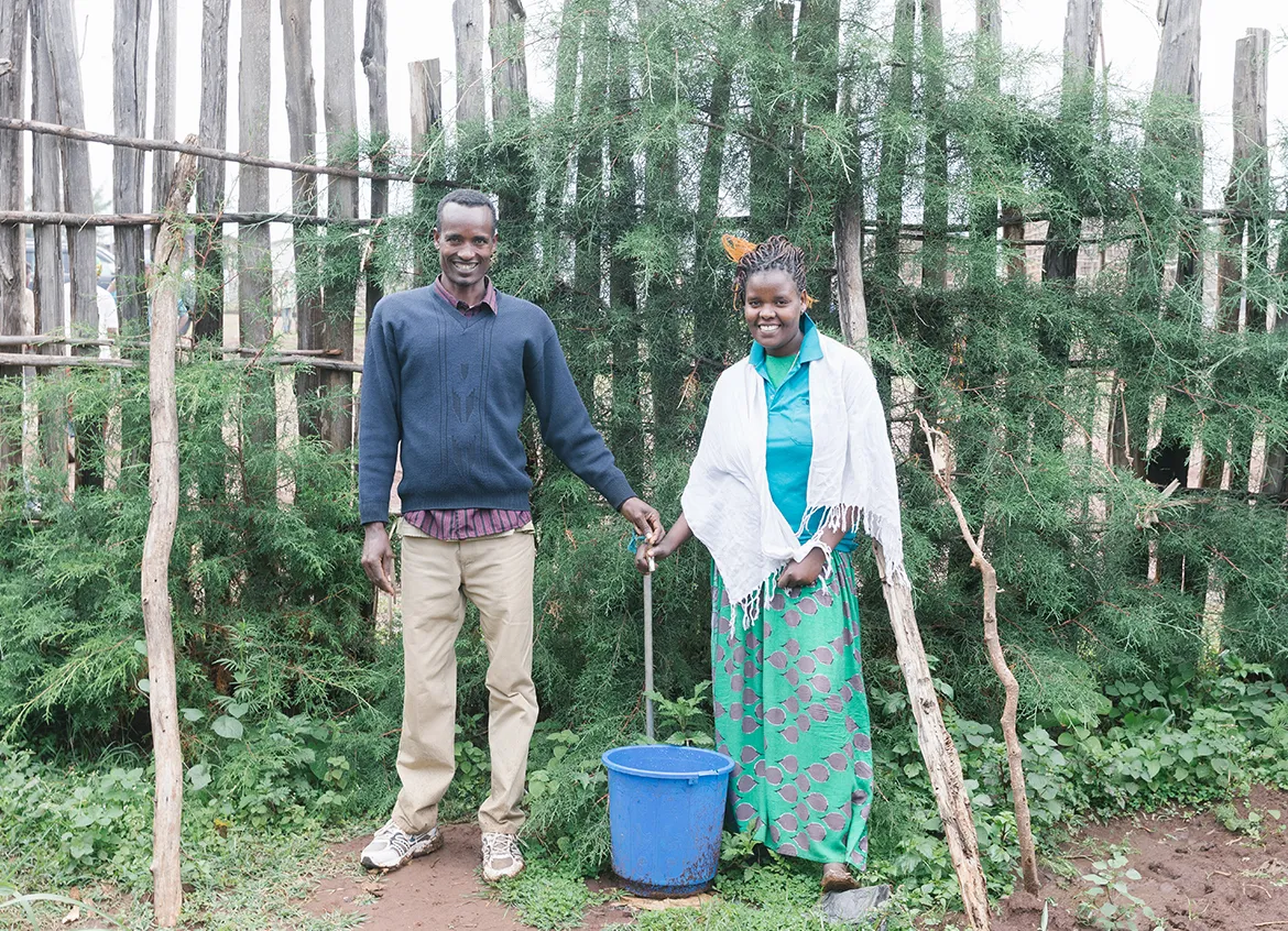 Man and woman smiling in front of their at-home water solution, a water spout.