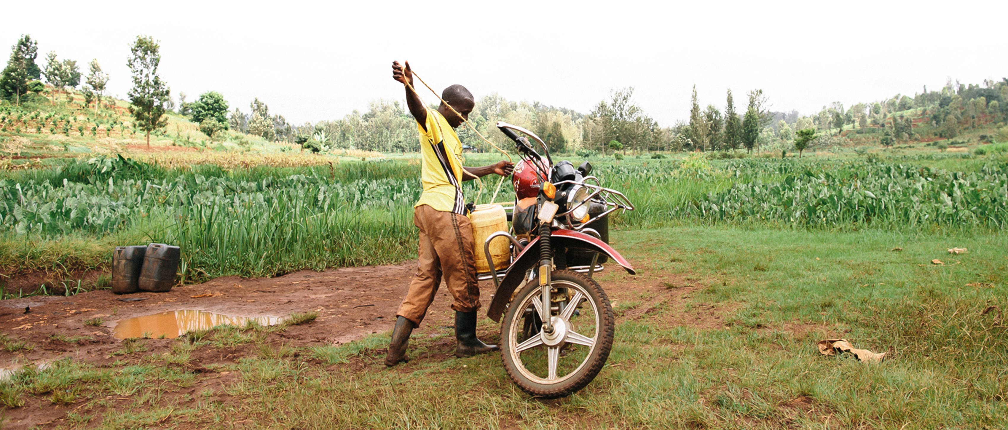 Ngugi collects water at a river in Kenya