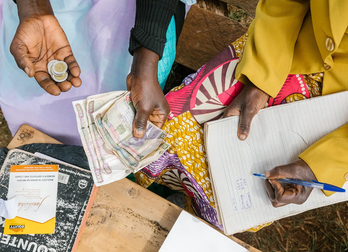 Women exchange money in Kenya.