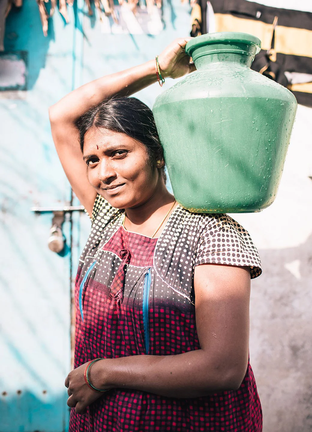 A woman carries a water vessel in Hyderabad, India
